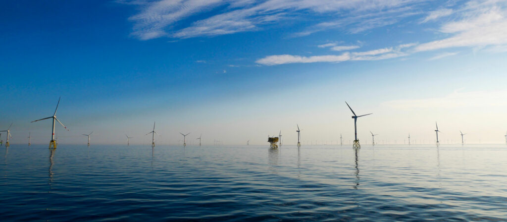 Mulitple wind turbines in the sea.